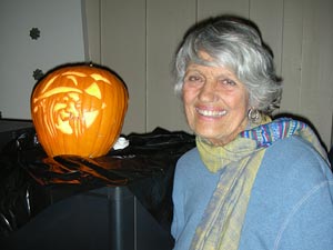 Garden Club attendee with a carved pumpkin
