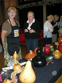 Attendees viewing the collection of artistic gourds