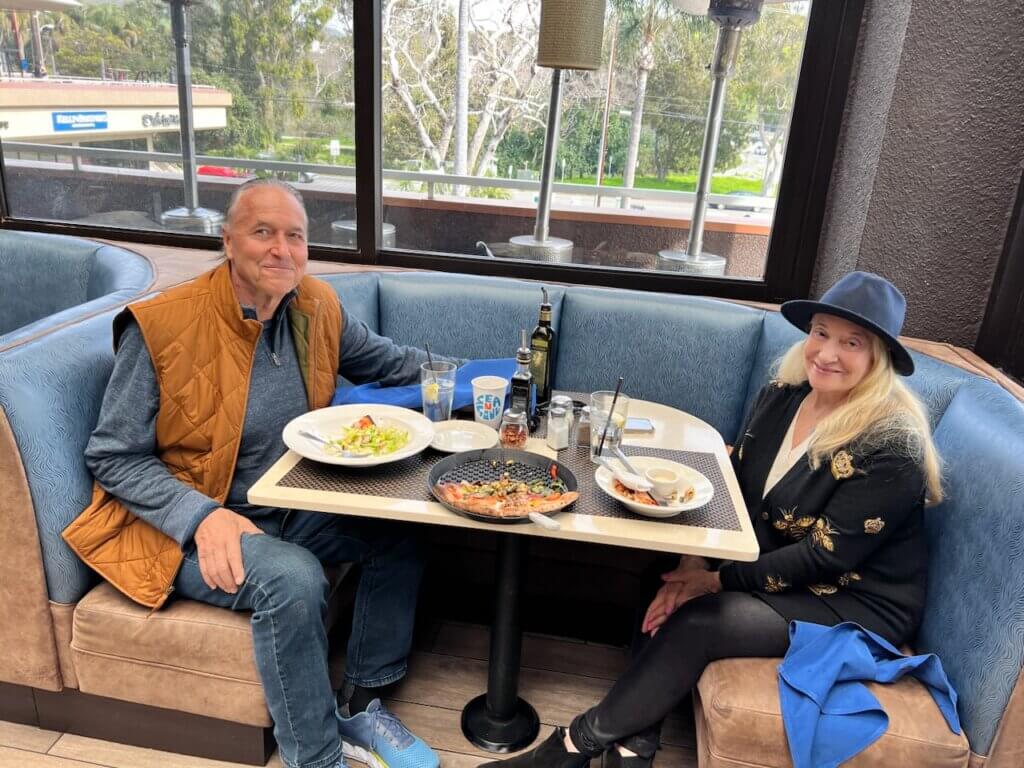 A couple sitting in a booth at Spruzzos