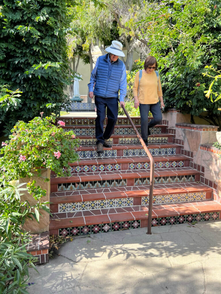 Malibu Garden Club President Glen Gessford and a garden club member walking down the beautifully tiled steps