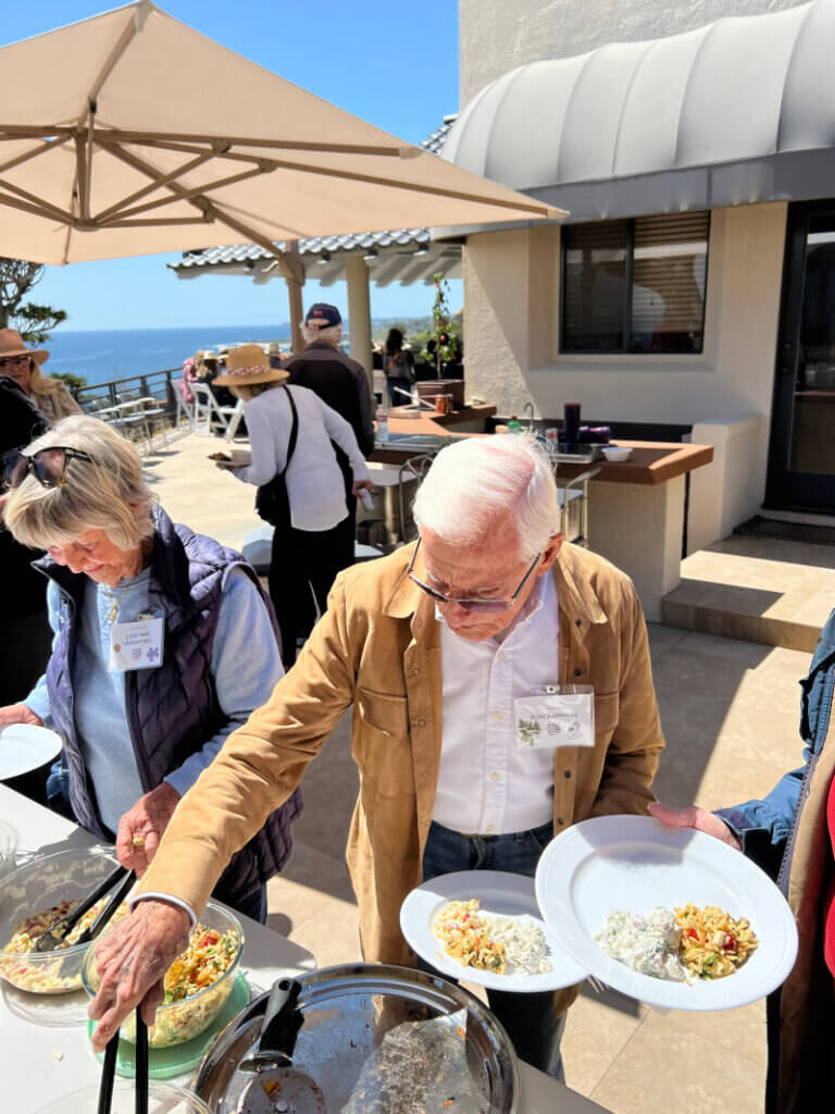 Members of the Malibu Garden Club dining along the ocean