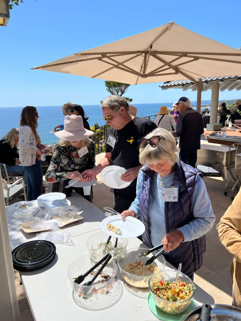 Members of the Malibu Garden Club dining along the ocean