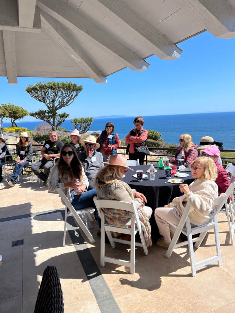 Members of the Malibu Garden Club dining along the ocean