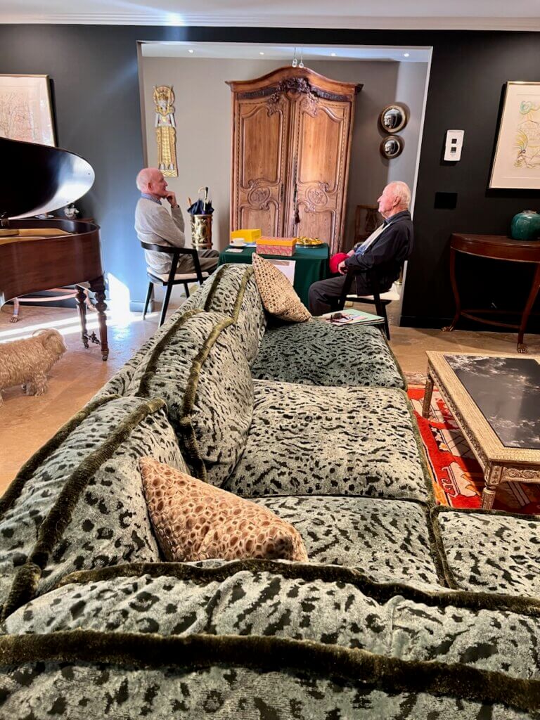 Two attendees lounging on facing chairs